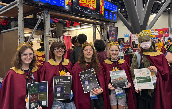 FIRST Robotics participants carrying FlyerFly campaign flyers at the World Championship